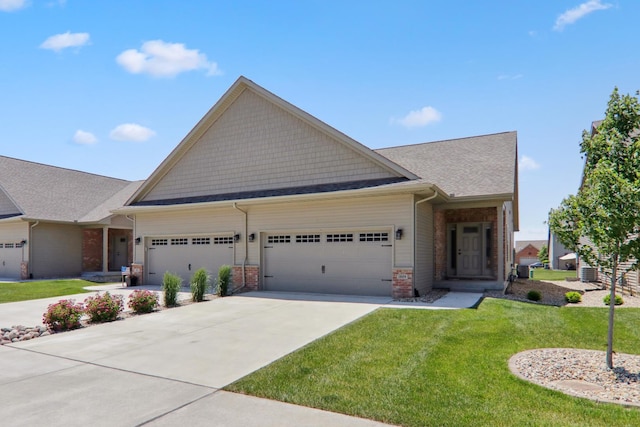 craftsman-style home with a garage, driveway, a front lawn, and brick siding