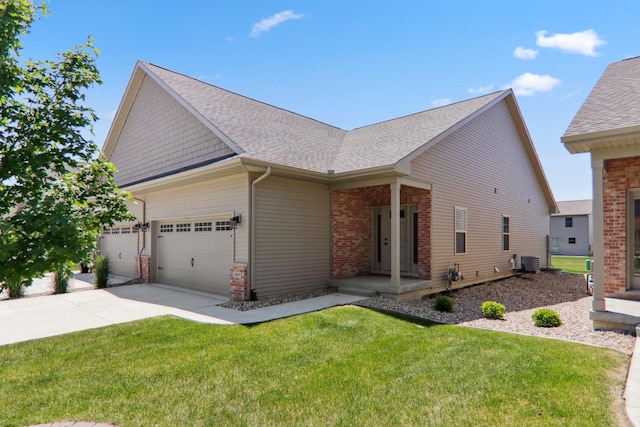 view of front of house with roof with shingles, central air condition unit, a front yard, a garage, and driveway