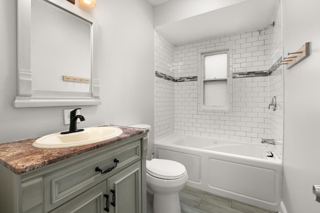 bathroom with toilet, washtub / shower combination, and vanity