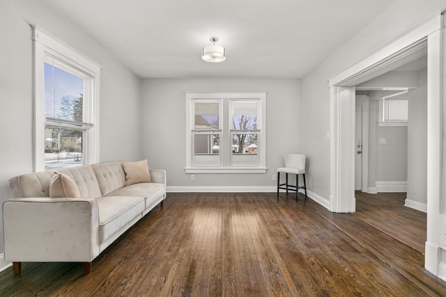 living area with dark wood-style floors and baseboards