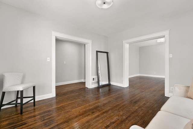 living area featuring dark wood-style floors and baseboards