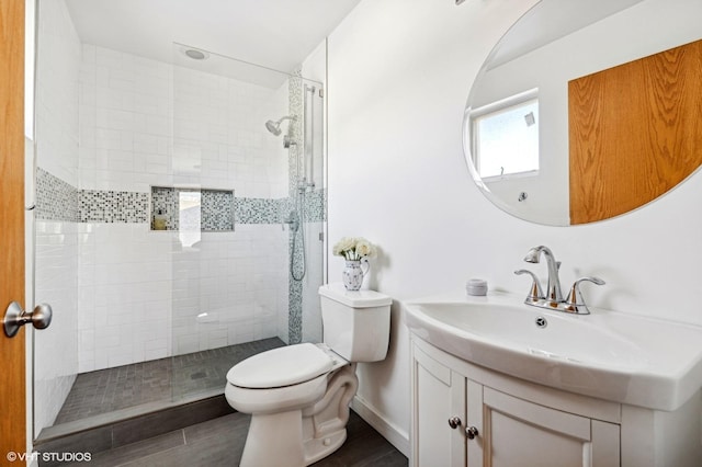 full bath with walk in shower, vanity, toilet, and baseboards