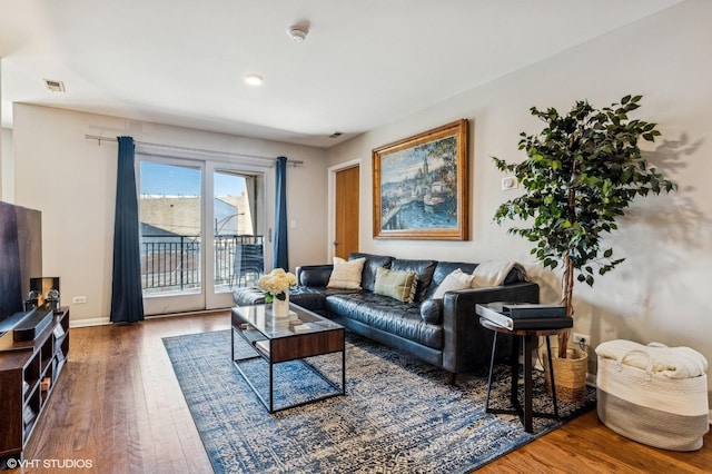 living room with visible vents and wood finished floors