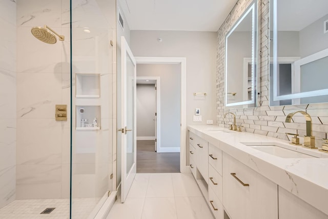 full bathroom with tasteful backsplash, a sink, a shower stall, and double vanity