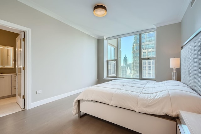 bedroom featuring a city view, crown molding, baseboards, and wood finished floors