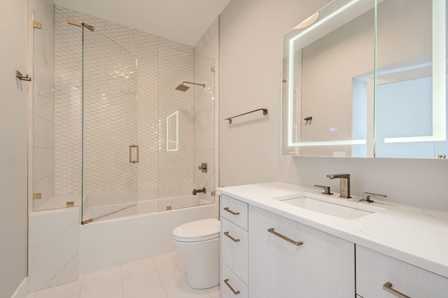 bathroom featuring vanity, toilet, and bath / shower combo with glass door