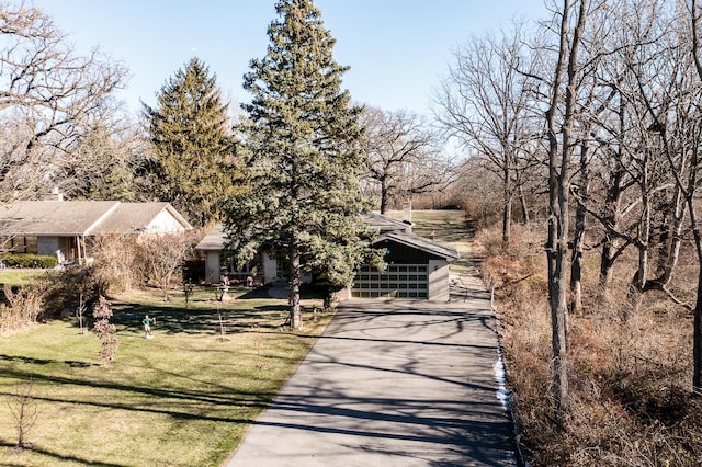 obstructed view of property featuring a front lawn