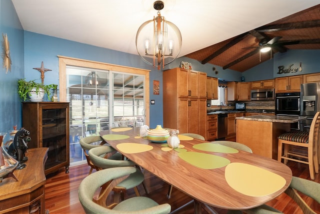 dining space featuring dark wood-style flooring, vaulted ceiling with beams, and ceiling fan with notable chandelier