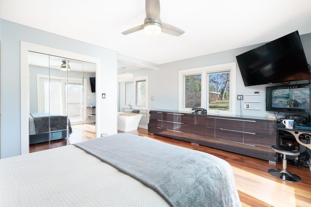 bedroom featuring ceiling fan, a closet, and wood finished floors