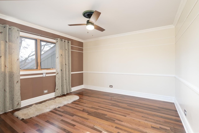 empty room with ceiling fan, crown molding, baseboards, and wood finished floors