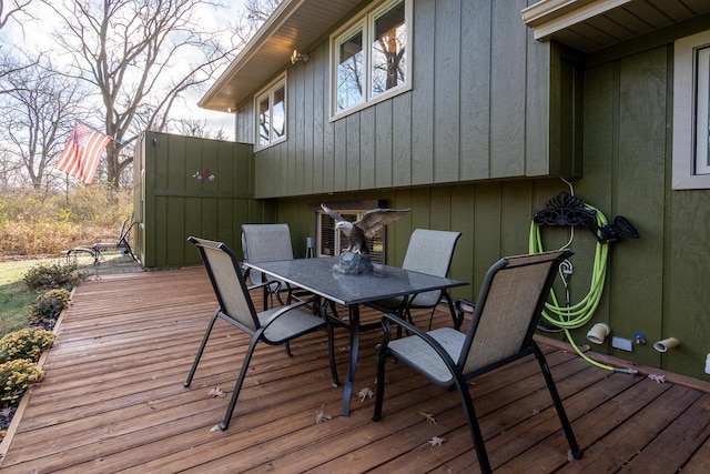 wooden terrace featuring outdoor dining area