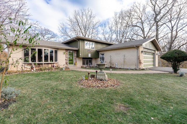 view of front facade with a garage, a front lawn, aphalt driveway, and brick siding