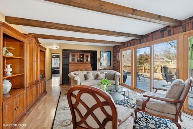 living room featuring light wood-style flooring and beamed ceiling