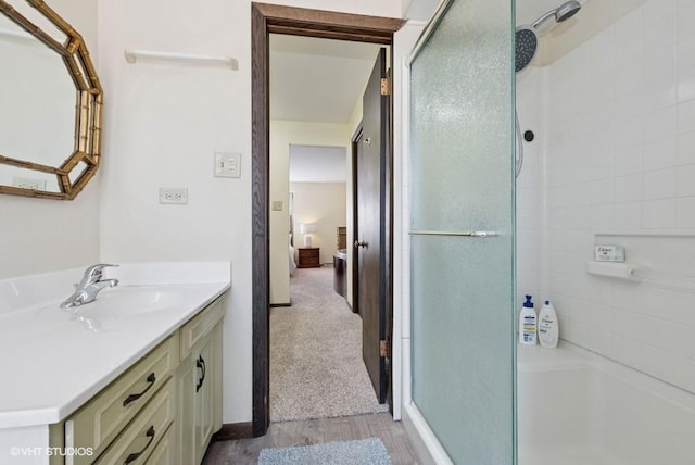 full bath with vanity, a washtub, and a shower with shower door