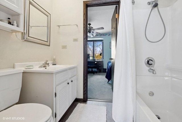 full bath with ceiling fan, vanity, toilet, and shower / bath combo with shower curtain