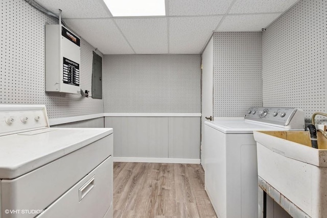 laundry room with laundry area, washer and dryer, wainscoting, electric panel, and light wood finished floors