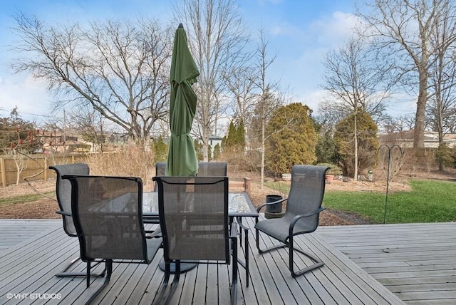 wooden terrace featuring outdoor dining space and fence private yard