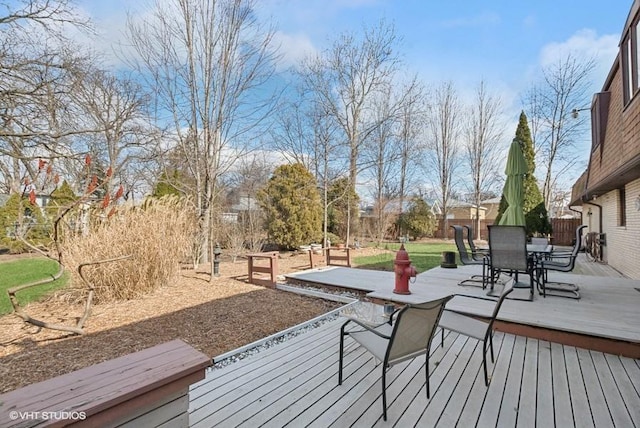 wooden terrace with outdoor dining space