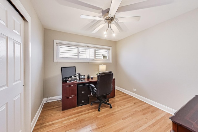 office space featuring light wood-style flooring, baseboards, and a ceiling fan