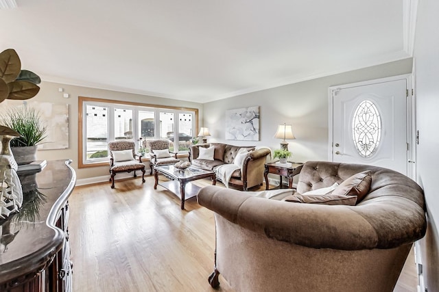 living area with light wood-style floors, crown molding, and baseboards