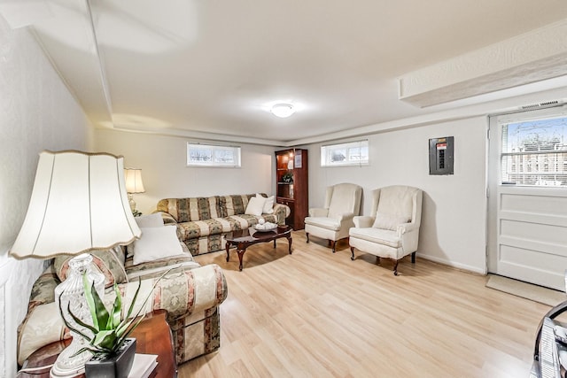 living area featuring light wood-type flooring and baseboards