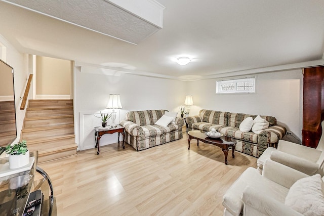 living area with stairway and wood finished floors