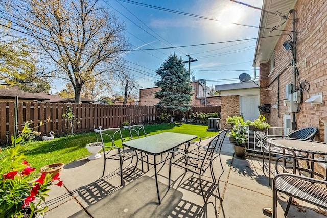 view of patio / terrace featuring central air condition unit, a fenced backyard, and outdoor dining space