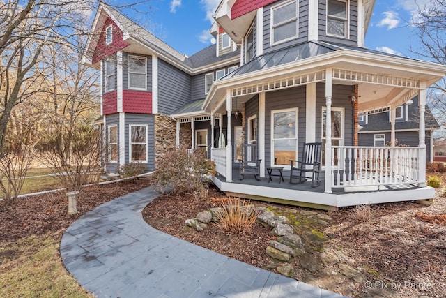 view of front of home featuring metal roof, covered porch, and a standing seam roof