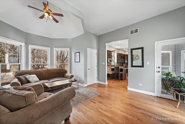 living room featuring visible vents, light wood-style flooring, baseboards, and ceiling fan