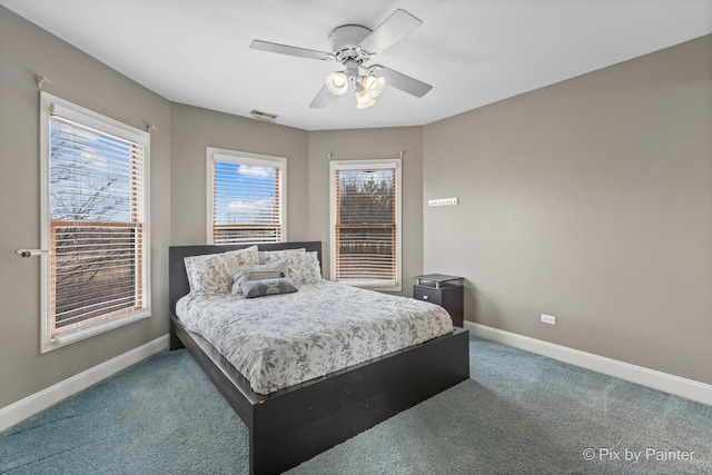 carpeted bedroom featuring visible vents, baseboards, and a ceiling fan