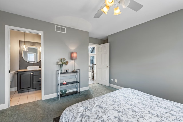 carpeted bedroom featuring visible vents, ceiling fan, connected bathroom, and baseboards