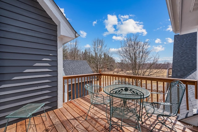 wooden deck with outdoor dining space