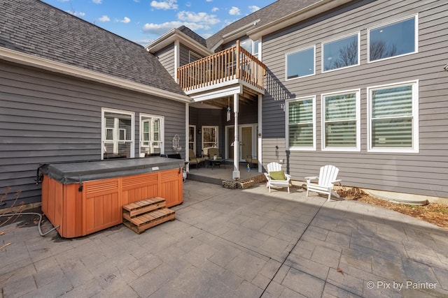 view of patio / terrace featuring a balcony and a hot tub