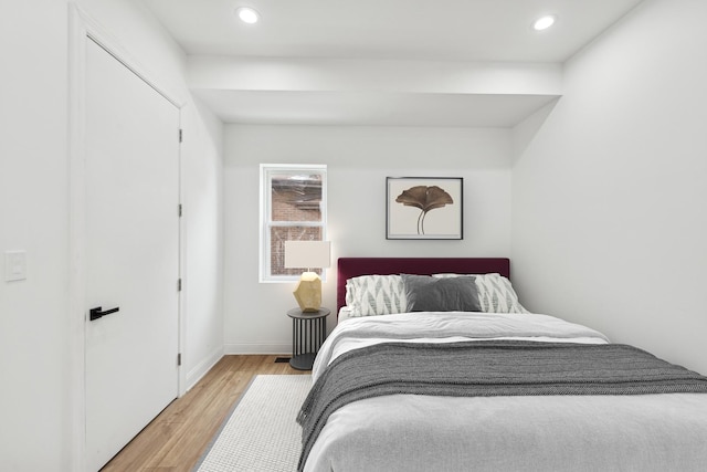 bedroom with light wood-style flooring, baseboards, and recessed lighting