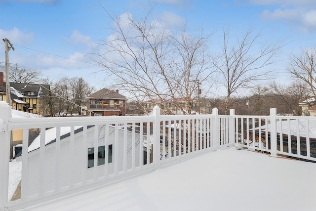 snow covered patio with a deck