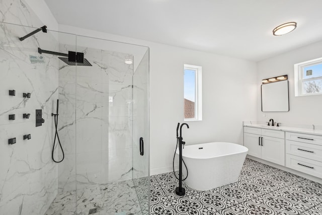 bathroom with a marble finish shower, baseboards, tile patterned floors, a freestanding bath, and vanity