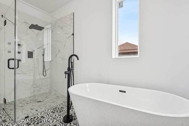 bathroom with a soaking tub and a marble finish shower