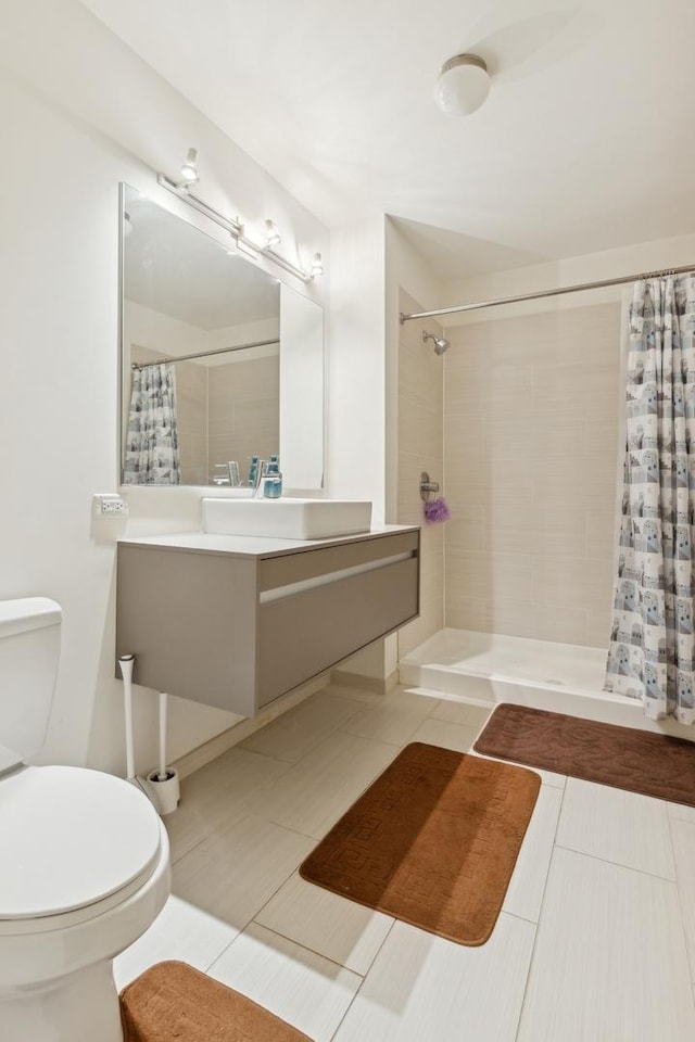 full bath featuring vanity, tile patterned flooring, a shower stall, and toilet