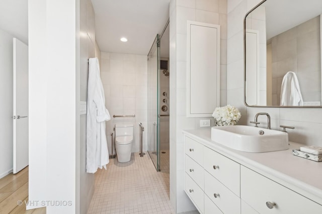 full bath with tile patterned flooring, toilet, recessed lighting, vanity, and tile walls