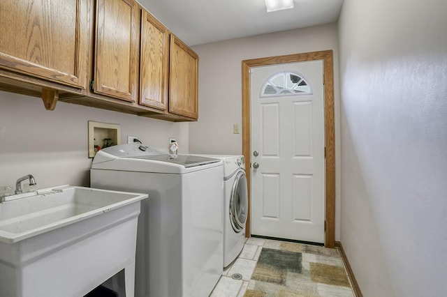 clothes washing area with cabinet space and washer and dryer