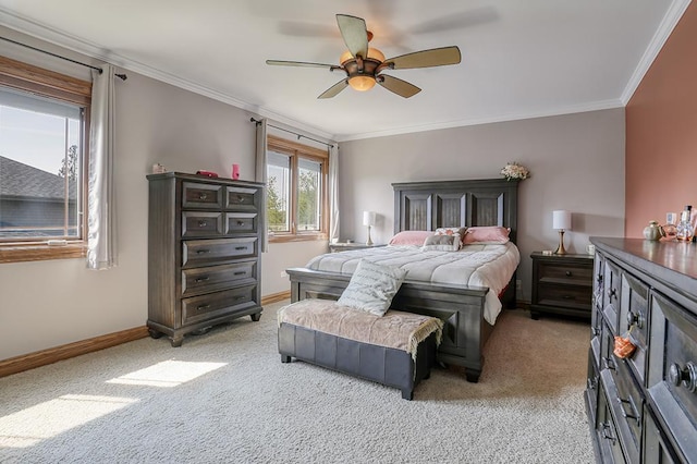 bedroom with light colored carpet, baseboards, ornamental molding, and a ceiling fan