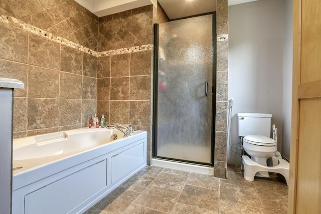 full bathroom with a shower stall, a garden tub, toilet, stone finish floors, and tile walls