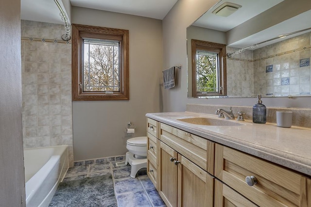 bathroom featuring toilet, vanity, and shower / bath combination