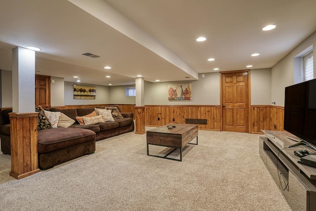 carpeted living room featuring a wainscoted wall, wooden walls, and recessed lighting