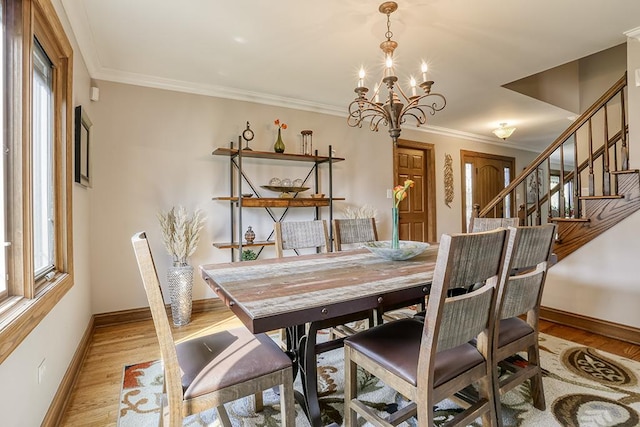 dining space featuring baseboards, a chandelier, stairs, plenty of natural light, and ornamental molding