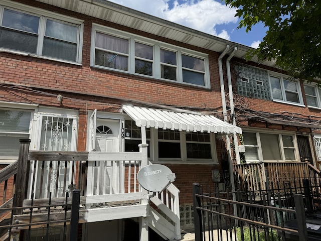 townhome / multi-family property featuring brick siding