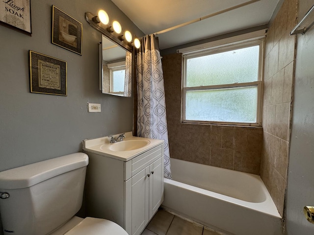 bathroom with tile patterned floors, vanity, toilet, and shower / bath combo with shower curtain