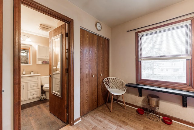 corridor featuring light wood-style floors and baseboards