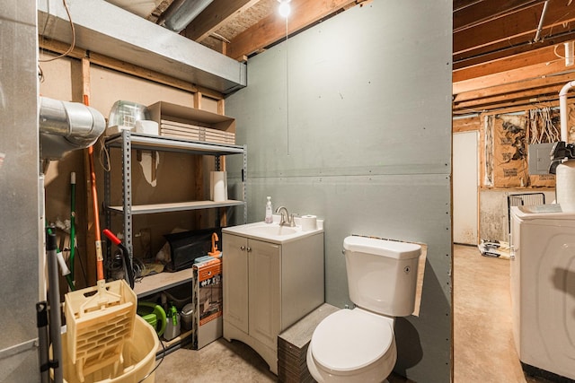 bathroom with washer / clothes dryer, toilet, and unfinished concrete floors