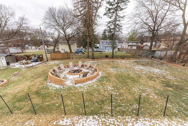 view of yard featuring a residential view, a fire pit, and fence